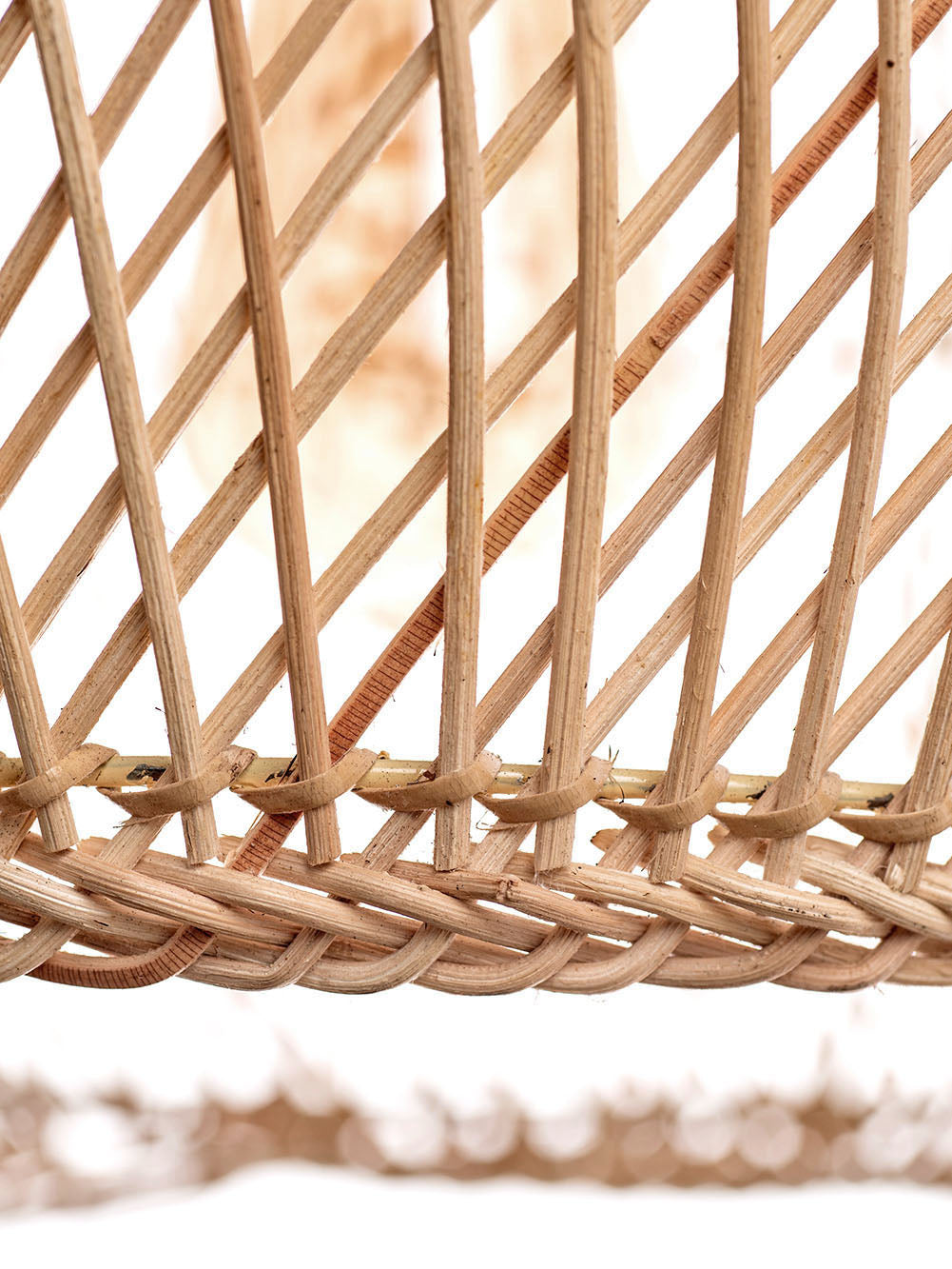 A natural color rattan pendant lamp with a teardrop shape and a wooden top.