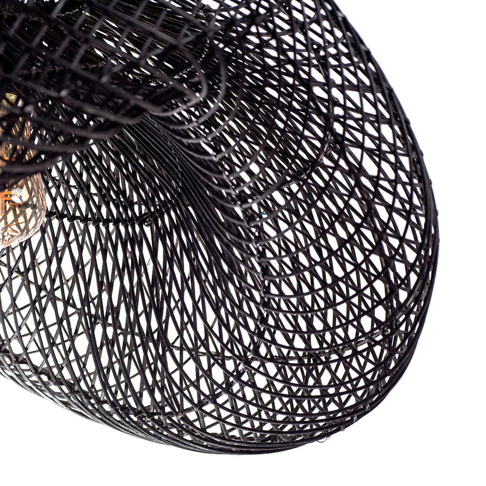 A black pendant lampshade made of rattan, with a rustic design and a visible light bulb at the center.
