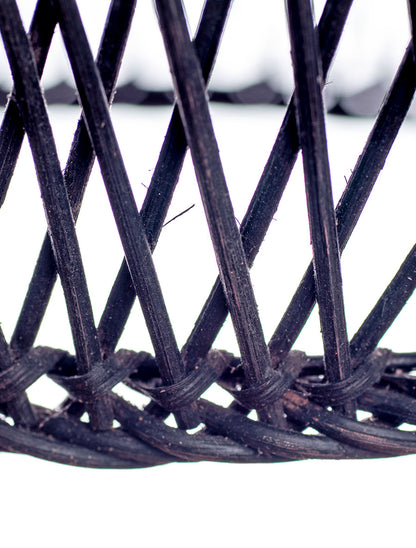 A black, conical pendant lampshade made of woven rattan with a wood tip, designed for hanging.