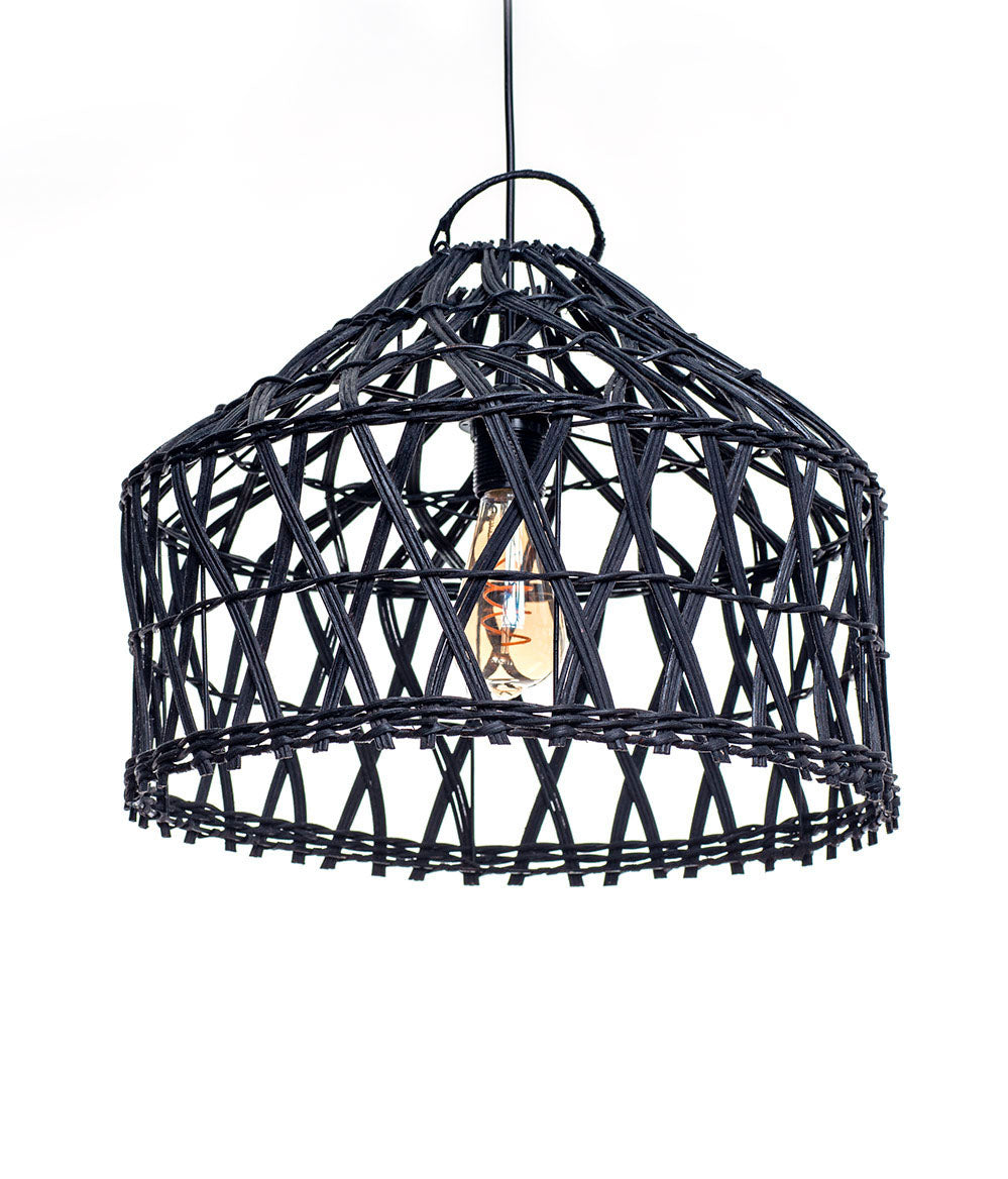 A black pendant lampshade made of rattan, with a rustic design and teak wood accents. A light bulb is visible inside the lampshade.