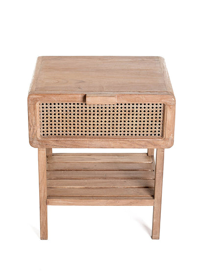 A small one-drawer teak wood side table with rattan netting on the front and a lower shelf, set against a white background.