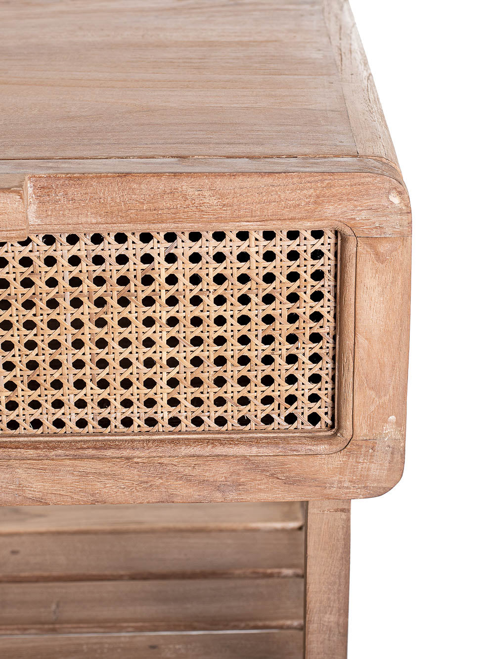 Close up look of small one-drawer teak wood side table with rattan netting on the front and a lower shelf, set against a white background.