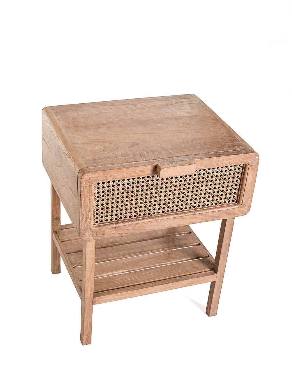 A small one-drawer teak wood side table with rattan netting on the front and a lower shelf, set against a white background, top view. 
