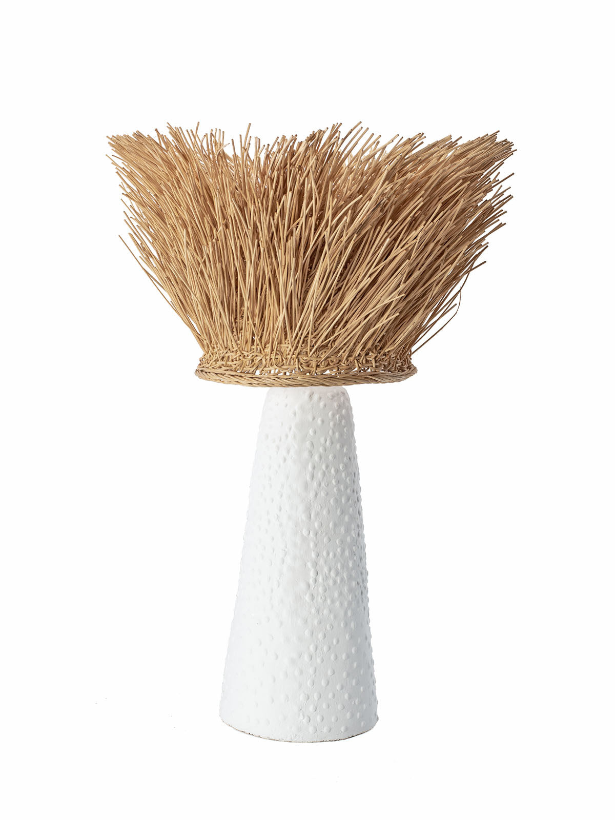 A table lamp with a ceramic base and a natural rattan lampshade, primarily in natural color with white at the bottom.