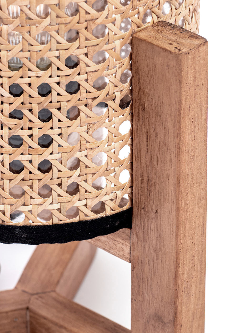A table lamp with a teak wood base and a cylindrical antique rattan shade, with a visible power cable.
