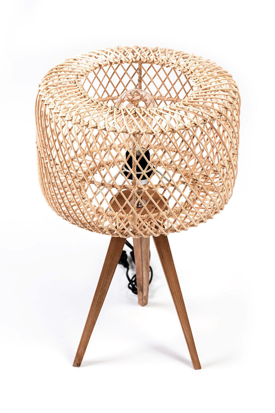 A three-legged table lamp with a teak wood base and a rattan shade, in natural color. The lamp is switched off and placed against a white background.