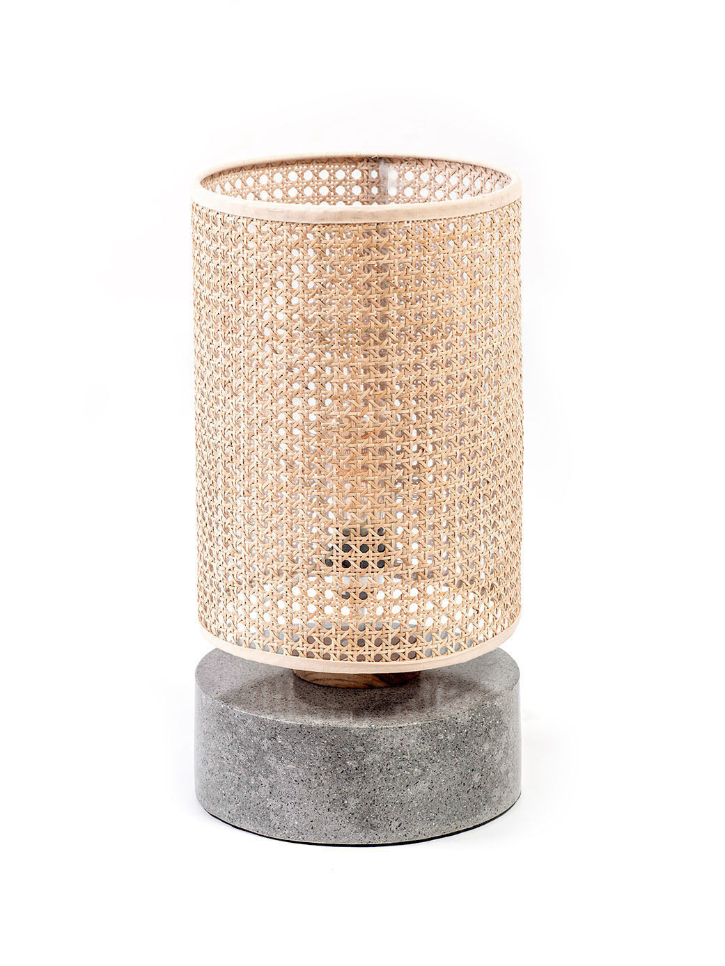 A table lamp with a rattan shade and a grey terrazzo base, standing on a flat surface.
