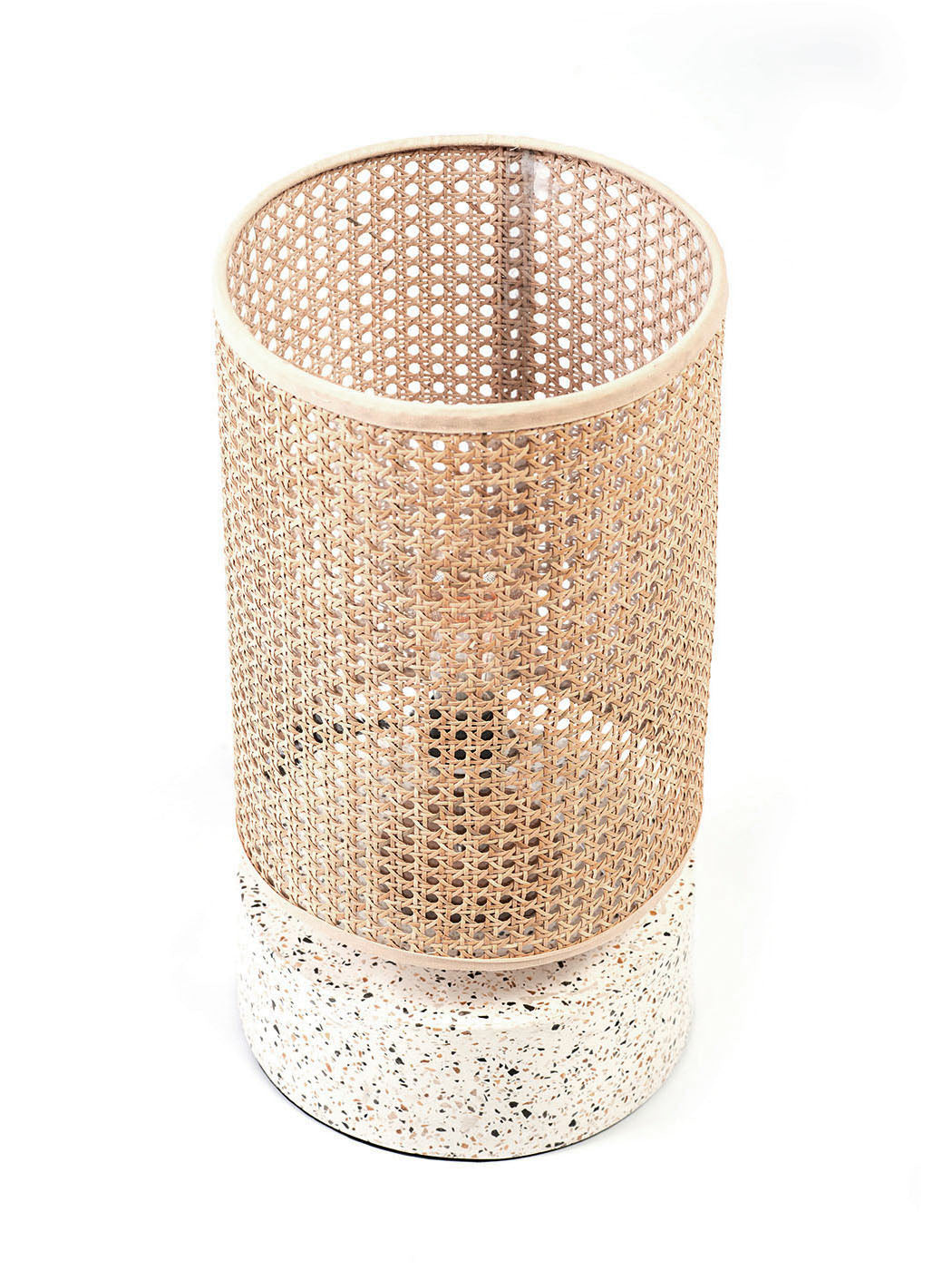 A table lamp with a white terrazzo base and a cylindrical rattan shade, suitable for a living room or bedroom setting.