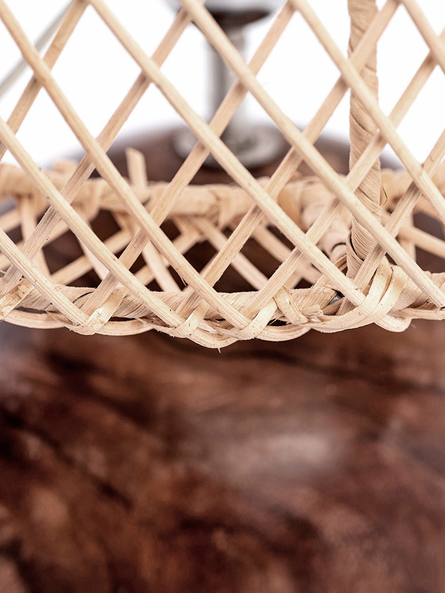 A table lamp with a spherical wooden base and a rattan lampshade.