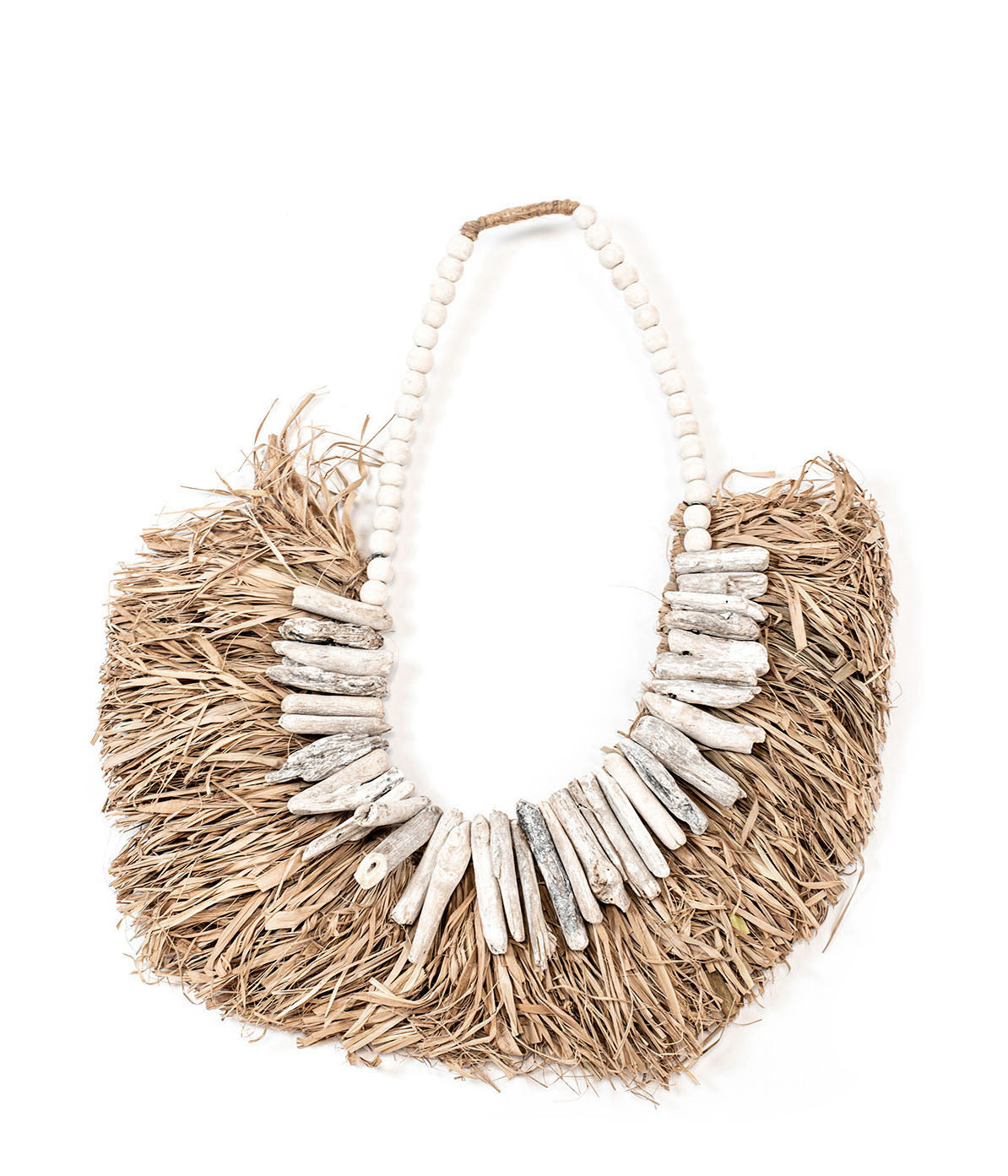 A wall decor piece featuring natural seaweed and small wooden details, predominantly in beige and white tones.