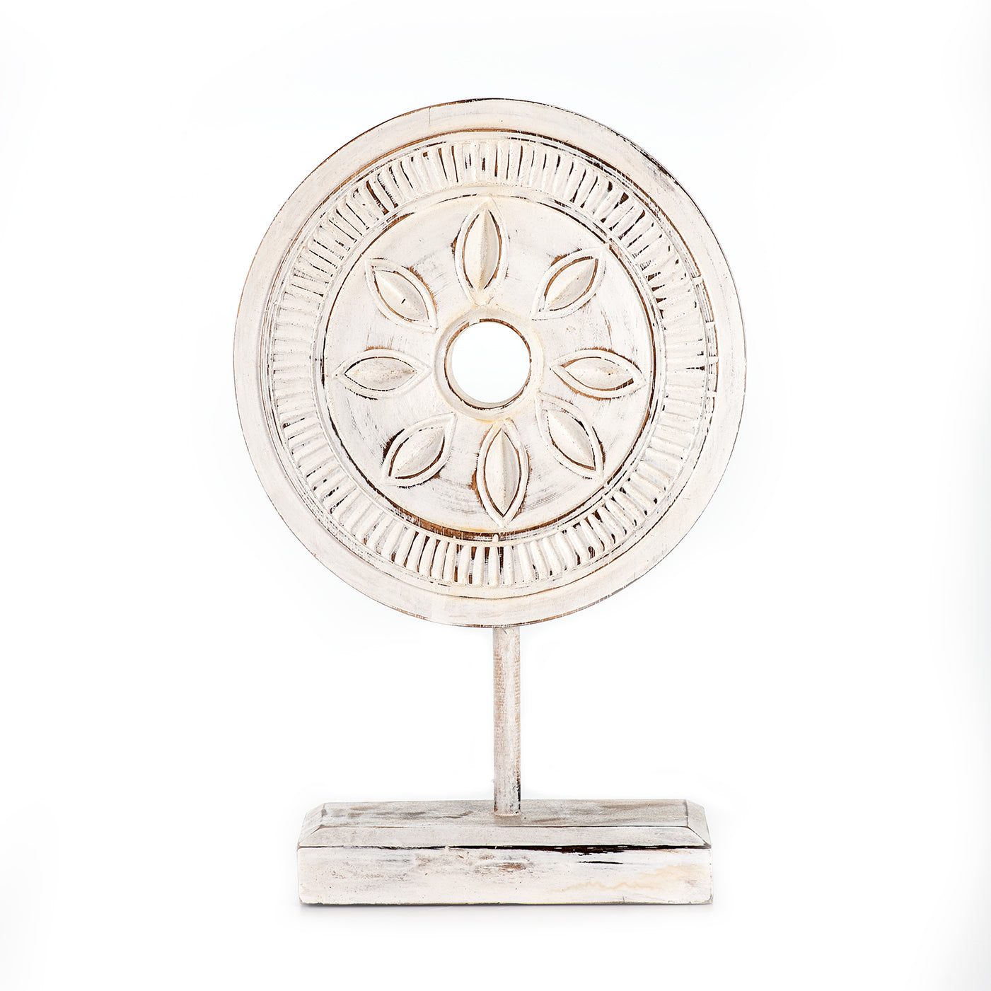 A decorative circular object on stand with intricate design against a white background.